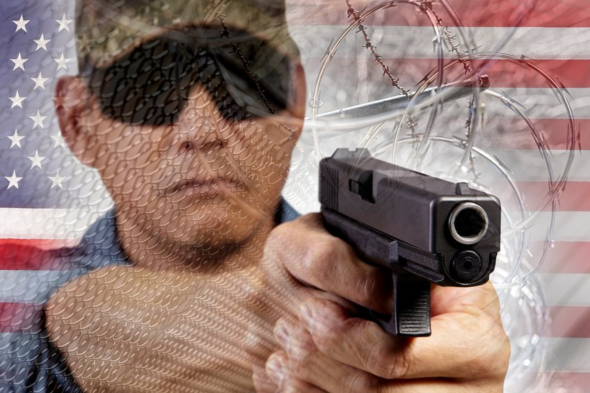 Lawman with gun and razor fence USA flag border barrier