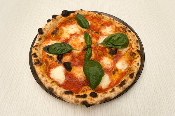 Traditional margherita pizza with cheese, tomato and basil