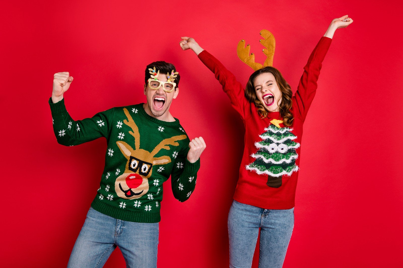 Two people having fun in Christmas Sweaters