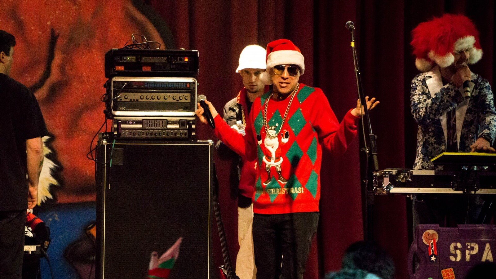 Man wearing Christmas sweater at live performance